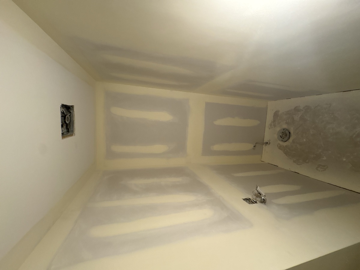Bathroom before renovation - bare drywall and mudding